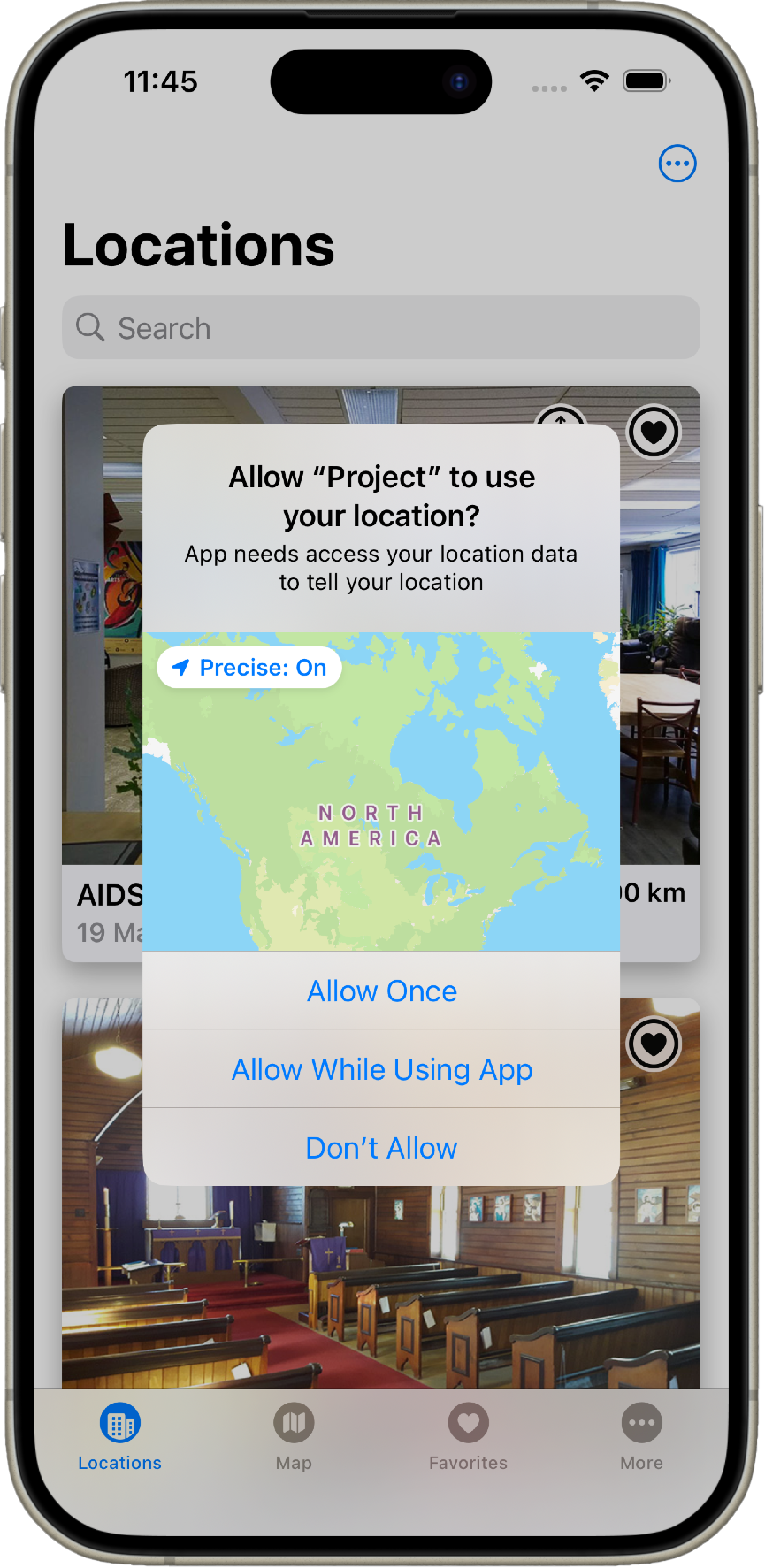 Screenshot of the iPhone app Locations with permission dialog for app Project to access user's location. The time is 11:45. Text on the screen says Allow 'Project' to use your location? with a confirmation prompt offering choices of Allow Once, Allow While Using App, and Don't Allow. Below the prompt, it explains that the app needs access to location data to tell your location. Current location is shown as North America, 10 km from AIDS. Additional buttons on the bottom bar include Map, Favorites, and More.